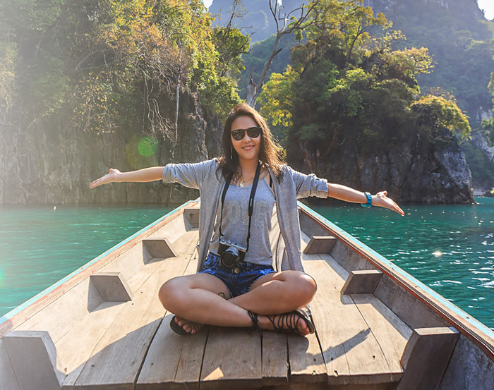 Woman feeling present and open to joy near the water